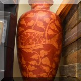 D48. Tall orange and red ceramic vase with fish decorations. - $18 